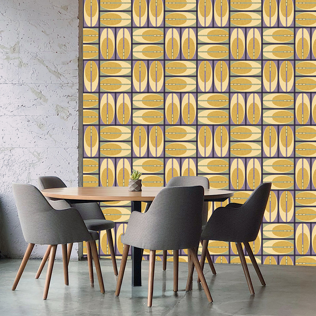 The artwork features a repeating geometric pattern of symmetrical shapes resembling elongated, curved diamonds or petals in various shades of blue and green. Each shape is split vertically with one half filled with a light blue and the other half filled with green or darker blue. The background is a light, almost pastel blue, which provides a soft yet vibrant backdrop. One of the blue shapes near the upper left contains a white starburst element, adding a focal point of brightness to the composition. The overall design conveys a modern, mid-century aesthetic with clean lines and harmonious color contrasts.